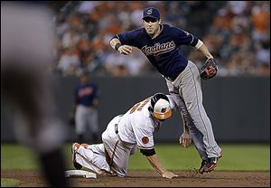 Baltimore's Chris Davis, bottom, breaks up a double-play attempt by Cleveland’s Jason Kipnis in the fifth inning on Tuesday.