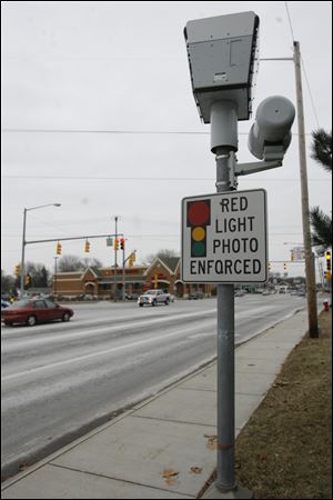 A Red-Light camera on the southbound corner of Secor and Monroe Streets.