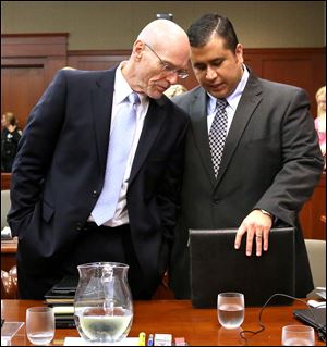 George Zimmerman, right, talks with defense attorney Don West in court Monday.