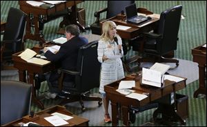 Sen. Wendy Davis, (D., Fort Worth), stands on a near empty senate floor as she filibusters in an effort to kill an abortion bill Tuesday in Austin, Texas.