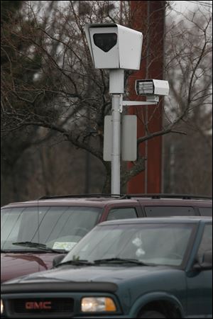 Toledo police officials say the city’s traffic cameras, such as this one, have reduced deaths in red-light crashes by nearly 40 percent.