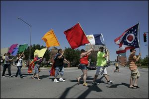 Rainbow flags are on display during the 2011 Toledo Pride parade.