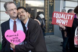John Lewis, left, and Stuart Gaffney embrace outside San Francisco's City Hall shortly before the U.S. Supreme Court ruling Wednesday clearing the way for same-sex marriage in California. 