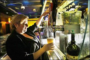 Daisy Rivas pours a Pabst Blue Ribbon beer at the Gold Room in Los Angeles. A glass of this quintessential cheap beer costs $4.  The price of low and mid-range beers is climbing at U.S. bars.