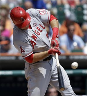 Los Angeles Angels' Mike Trout hits a double against the Detroit Tigers in the third inning of a baseball game in Detroit today.