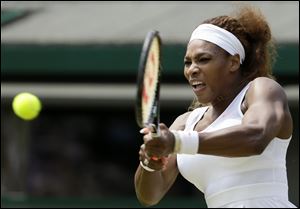 Serena Williams of the United States returns to Caroline Garcia of France during their Women's second round singles match at the All England Lawn Tennis Championships in Wimbledon, London.