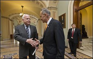Sen. John McCain (R., Ariz), left, and Sen. Charles Schumer (D., N.Y.), right, were two of the authors of the immigration reform bill, shown here before its passage by the Senate.