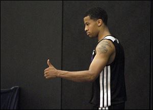 Michigan point guard Trey Burke gives a thumbs up during a pre-draft workout.