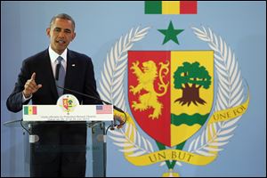 President Obama gestures during a news conference at the Presidential Palace in Dakar, Senegal today.