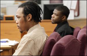 Keshawn Jennings, left, and Antwaine Jones, right,  sit at the defendants table.