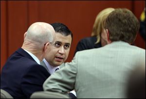 George Zimmerman, center, talks to his defense team during his trial in Seminole circuit court in Sanford, Fla. Thursday, June 27, 2013. Zimmerman has been charged with second-degree murder for the 2012 shooting death of Trayvon Martin. 
