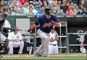 Cleveland’s Nick Swisher hits an RBI-single in the eighth inning that drives in the go-ahead run against the Chicago White Sox. 
