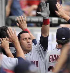 Cleveland Indians' Asdrubal Cabrera celebrates with teammates in the dugout after scoring on a Jason Kipnis double during the second inning.