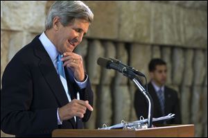 U.S. Secretary of State John Kerry smiles at a question from a reporter during a Tel Aviv news conference about his trip to the Middle East. Kerry engaged in breakneck shuttle diplomacy to coax Israel and the Palestinians back into peace talks over a four-day span with multiple trips to Jordan and Israel and a stop in the West Bank town of Ramallah.