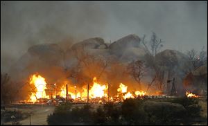 Homes burn as the Yarnell Hill Fire burns in Glenn Ilah on Sunday.