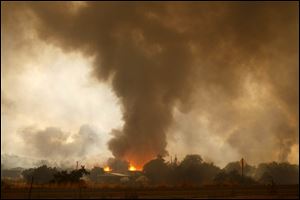 A wildfire destroys homes in the Glenn Ilah area near Yarnell, Ariz. on Sunday.