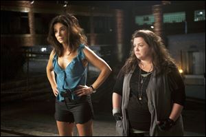 Sandra Bullock, left, stars as FBI Special Agent Sarah Ashburn, and Melissa McCarthy, as Boston Detective Shannon Mullins, in a scene from the film, 'The Heat.'