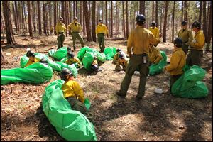 A training course by Arizona area firefighters, using emergency shelters, such as the ones used by the 19 firefighters who died in the wildfire. 
