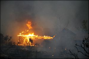 Homes burn as the Yarnell Hill Fire approaches Glenn Ilah., near Yarnell, Ariz. 