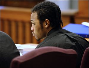 Keshawn Jennings listens as James Moore testifies during the trial of Jennings and Antwaine Jones in Lucas County Common Pleas Court.