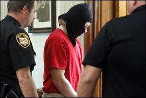 Michael Aaron Fay, 17, is escorted out of the courtroom after a hearing to transfer the case from juvenile court to Putnam County Common Pleas Court, where the teenager can be tried as an adult for the deaths of  Blaine Romes, 14, and Blake Romes, 17.