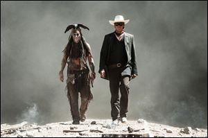 Johnny Depp, left, as Tonto, and Armie Hammer, as The Lone Ranger, in a scene from the film, 