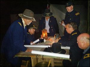 Bob Minton, seated second from right,  strategizes  with other commanding officers during the Blue Gray Alliance’s 150th anniversary re-enactment of the Civil War’s Battle of Gettysburg. 