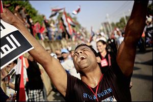 An opponent of Egypt’s Islamist President Mohammed Morsi chants slogans during a protest outside the presidential palace in Cairo.