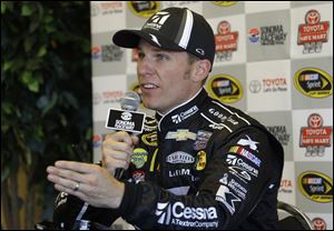Jamie McMurray speaks during a news conference after qualifying for the pole position in the NASCAR Sprint Cup series auto race in Sonoma, Calif., in June.