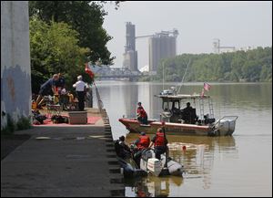 Divers search the Maumee River for human remains.