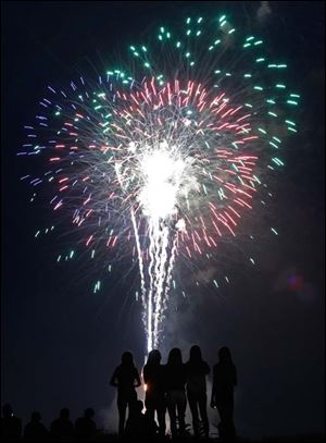 A group of girls stand on a mound inside Fort Meigs to watch the fireworks during the Star Spangled Banner celebration in Perrysburg.