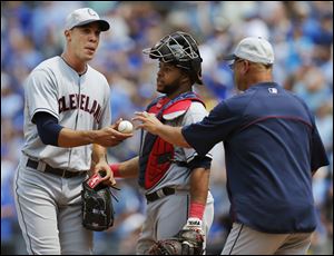 Cleveland Indians starting pitcher Ubaldo Jimenez, left, hands the ball to manager Terry Francona, right, after giving up a grand slam during the sixth inning.