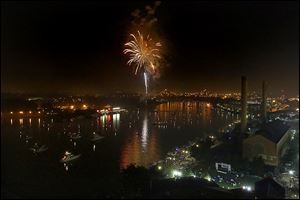 Fireworks explode over the Maumee River on July 4  in downtown Toledo during the Red, White, KABOOM celebration.  