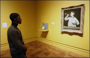 Keon Pearson of Toledo enjoys the last day of the popular Manet exhibit Tuesday at the Toledo Museum of Art.
