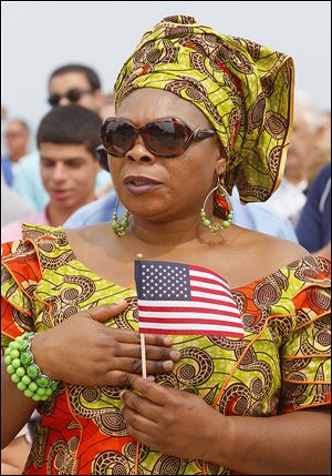 Pammella Ngefor of Sylvania, originally from Cameroon, recites the Pledge of Allegiance in a naturalization ceremony and delayed enlistment at Perry’s Victory and International Peace Memorial.