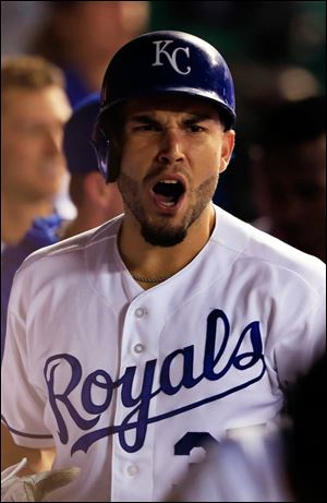 Eric Hosmer of the Kansas City Royals is congratualted by teammates in the dugout after hitting the go-ahead home run during the 7th inning Wednesday in Kansas City.
