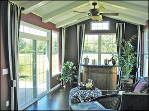 This bright sunroom offers wonderful views of the golf course. 