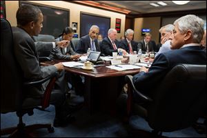 President Obama meeting with members of his national security team to discuss the situation in Egypt in the Situation Room of the White House Wednesday.