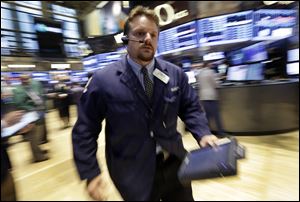 Trader Michael Milano works on the floor of the New York Stock Exchange today.  Robust hiring in the U.S. boosted the stock market.
