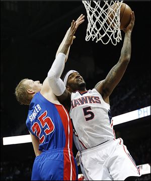 Josh Smith (5) goes up for a basket against Pistons small forward Kyle Singler last season. Smith will be on Detroit's side next season.