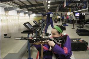 Sarah Sutton, 15, of Oak Harbor steadies herself before shooting at the Ottawa County 4H Club shooting team’s practice session. The team, which has members from three counties, won the Ohio Junior Olympic 3 Position championship.