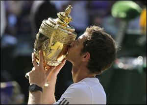 Andy Murray of Britain poses with the trophy after defeating Novak Djokovic of Serbia during the Men's singles final match at the All England Lawn Tennis Championships in Wimbledon today.