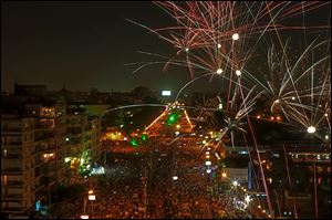 Fireworks burst overhead as  opponents of Moham-med Morsi rally outside the presidential palace in Cairo on Sunday. It was the eighth straight day of gigantic demonstrations in the city. 