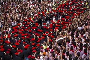 Revelers sing as a band plays after the launch of the 'Chupinazo' rocket, to celebrate the official opening of the 2013 San Fermin fiestas, Saturday in Pamplona, Spain. 