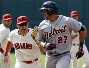 Cleveland Indians' Asdrubal Cabrera, left, tags out Detroit Tigers' Jhonny Peralta after Peralta attempted to advance to second base on a single in the third inning Saturday in Cleveland.