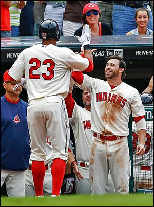 The Indians' Jason Kipnis, right, congratulates Michael Brantley after Brantley hit a two-run home run off the Tigers’ Al Alburquerque in the eighth.