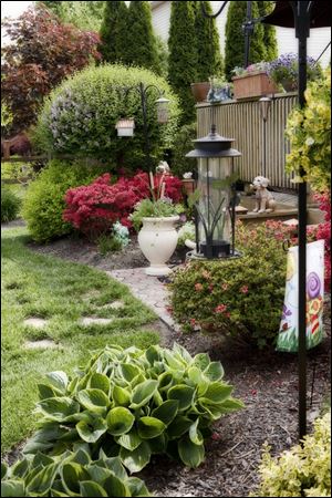 The garden of Marion Rapp and Terry McElmurry will be on the Bedford Flower and Garden Club tour. Ms. Rapp says it shows what can be done in a small space.