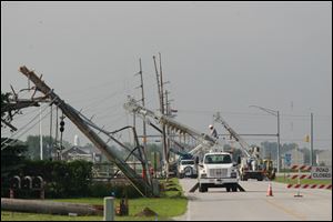 About 15 City of Bowling Green Department of Public Utilities power transmission poles are down and power is out along Dunbridge Road in Bowling Green. The damage is immediately south of a power substation.