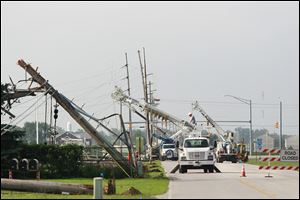 More than a dozen Bowling Green Department of Public Utilities electric poles were topped by a Sunday storm, leaving power out along Dunbridge Road in Bowling Green. Electric service was expected to be restored today.