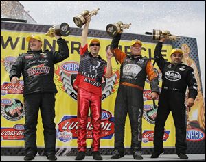 Pro Stock's Mike Edwards, left, Pro Stock Motorcycle's Matt Smith, Funny Car driver Johnny Gray, and Top Fuel racer Khalid Balooshi celebrate their victories in Norwalk.